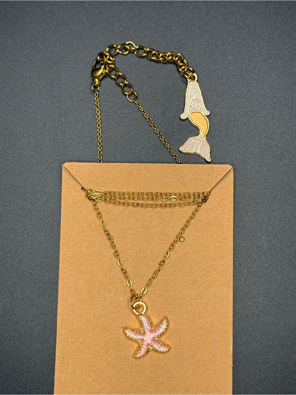 Gold tone Starfish Pendant Necklace with Pink Enamel mermaid in the back.